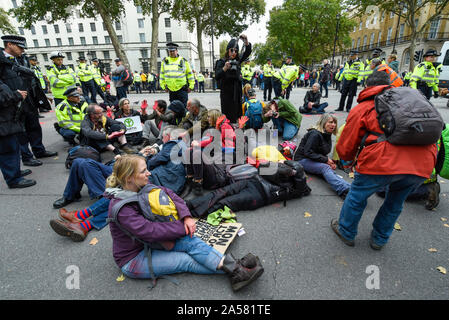 London, UK.  18 October 2019.  Climate activists from Extinction Rebellion protest outside Downing Street.  Activists are calling on the government to take immediate action on the negative effects of climate change.  Credit: Stephen Chung / Alamy Live News