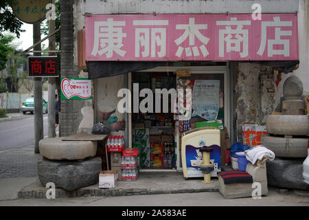 Man riding a tricycle moped with cargo space over the road Stock Photo