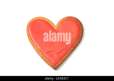 Decorated heart shaped cookie with cracks on white background, top view. Love concept Stock Photo