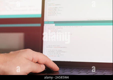 Programmer hands on laptop keyboard close up view Stock Photo
