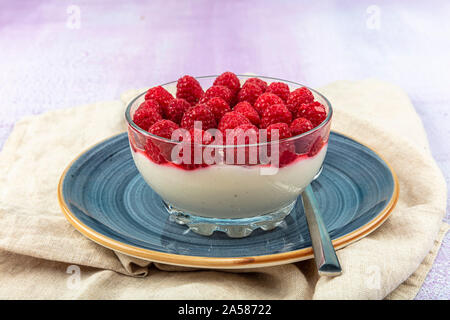 Delicious italian dessert panna cotta with berry sauce. Vanilla pudding decorated blackberries and raspberries. Stock Photo