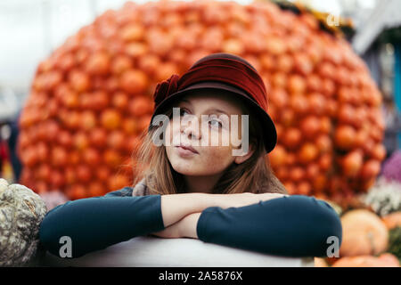 A beautiful red-haired teenage girl in retro hat  Stock Photo