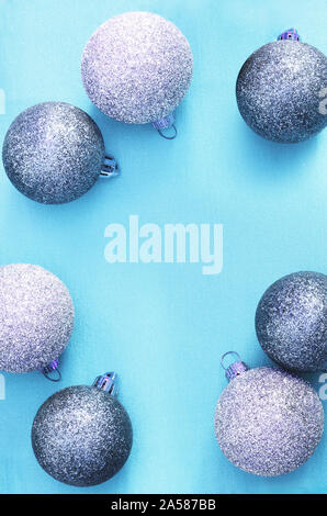 New Year or Christmas background: blue glass balls over blue painted backdrop, top view, copy space. Stock Photo