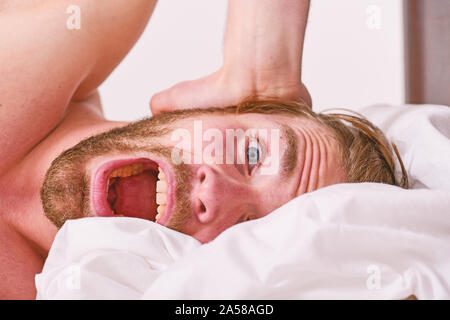 How to get up in morning feeling fresh. Late morning overslept. Morning routine tips to feel good all day. Man handsome guy lay in bed in morning. Tips on how to wake up feeling fresh and energetic. Stock Photo