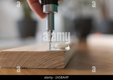 Tightening a screw during a DIY project. Stock Photo