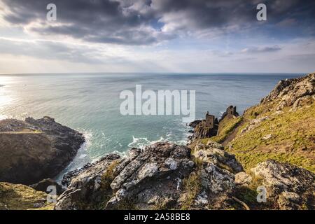 Bright scenery of an ocean with a mountain at the shore in Mining Ruins, Botallack, Cornwall, UK Stock Photo