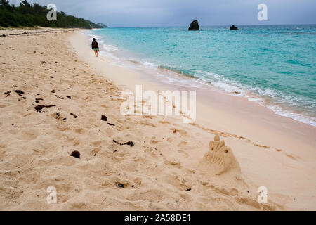 Walking on Horseshoe Bay beach in Bermuda. Stock Photo