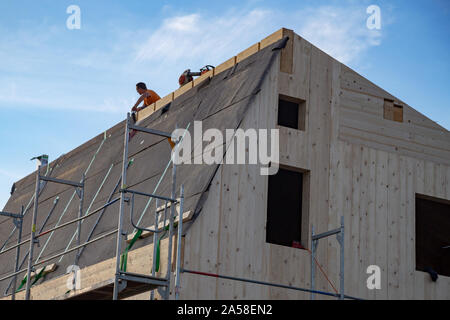 Carpenters at work on a new house under construction Stock Photo