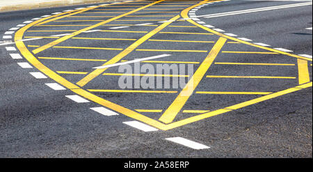 White and yellow road lines on the city street Stock Photo
