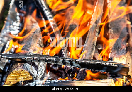 Campfire with burning wood outdoors, close up Stock Photo