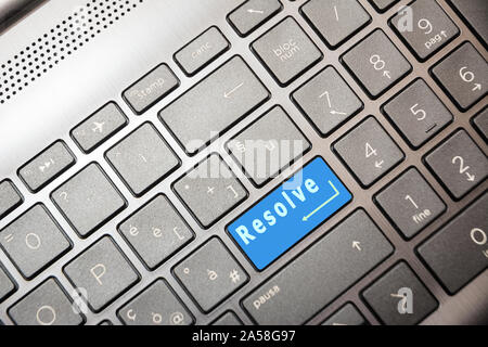 Blue button on the computer with the text Resolve Stock Photo