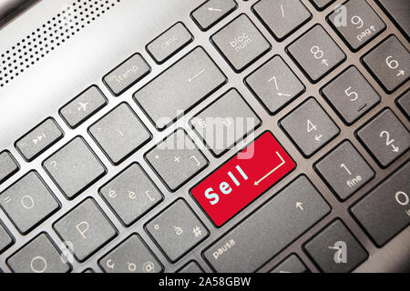 Red button on the computer with the text Sell Stock Photo