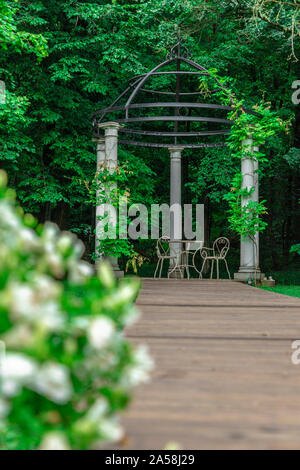 White gazebo for weddings in the woods on a cloudy day Stock Photo