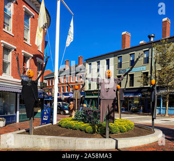 Portsmouth, NH / USA - Oct 16, 2018: Five Scarecrows of the Port on display in Market Square. The pumpkin-headed figures are erected by volunteers. Stock Photo
