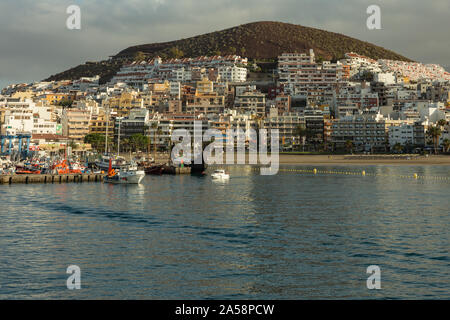 Harbor in Los Cristianos, Tenerife, Spain - May 25, 2019: On the left - fishing boats and tourist yachts early morning in the port of Los Cristianos. Stock Photo