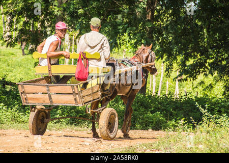 Two men transporting material using a horse and buggy; Camaguey, Cuba Stock Photo