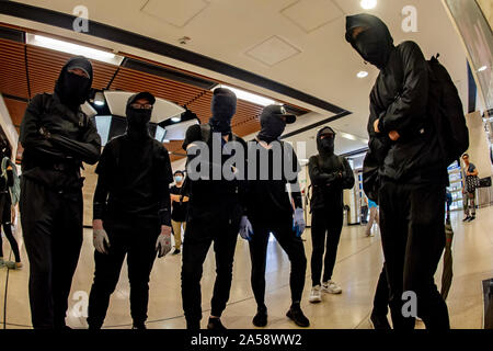 Crowds of protestors in a shopping Mall in Hong Kong gather before attacking and destroying the interior of the mall Stock Photo