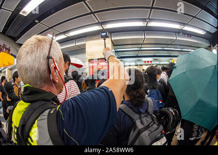 Journalists crowd around protestors in a shopping mall in Hong Kong Stock Photo