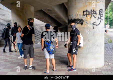 Gangs of protestors in Hong Kong gather in the late afternoon in anticipation of an evening of disruption Stock Photo