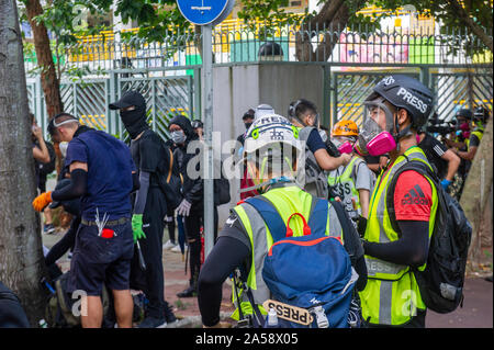 Gangs of protestors in Hong Kong gather in the late afternoon in anticipation of an evening of disruption Stock Photo