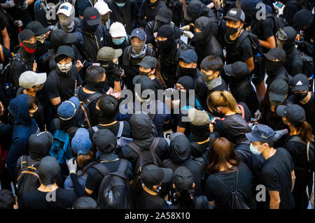 Crowds of protestors in a shopping Mall in Hong Kong gather before attacking and destroying the interior of the mall Stock Photo