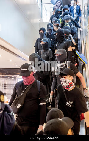 Crowds of protestors in a shopping Mall in Hong Kong gather before attacking and destroying the interior of the mall Stock Photo