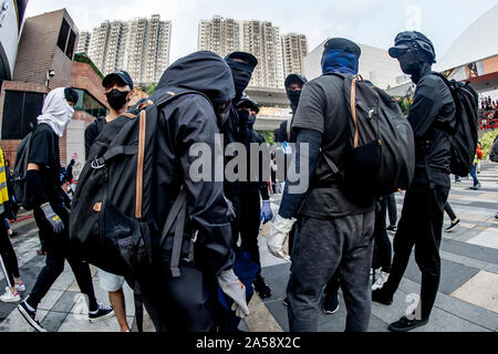 Gangs of protestors in Hong Kong gather in the late afternoon in anticipation of an evening of disruption Stock Photo