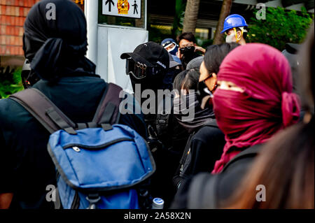 Gangs of protestors in Hong Kong gather in the late afternoon in anticipation of an evening of disruption Stock Photo