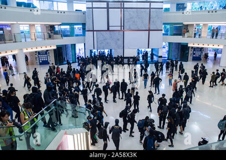 Crowds of protestors in a shopping Mall in Hong Kong gather before attacking and destroying the interior of the mall Stock Photo