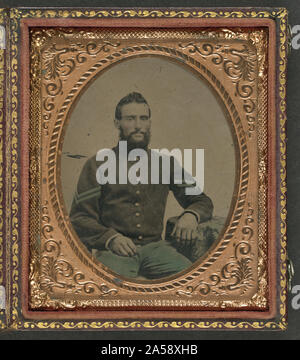 Unidentified soldier in Union infantry corporal's uniform sitting with arm resting on table Stock Photo