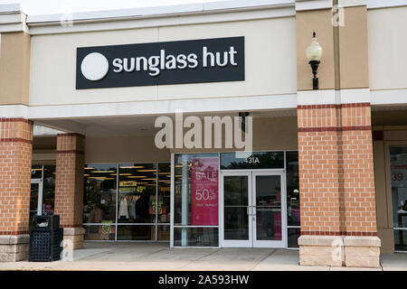 A logo sign outside of a Sunglass Hut retail store location in Queenstown, Maryland on August 5, 2019. Stock Photo