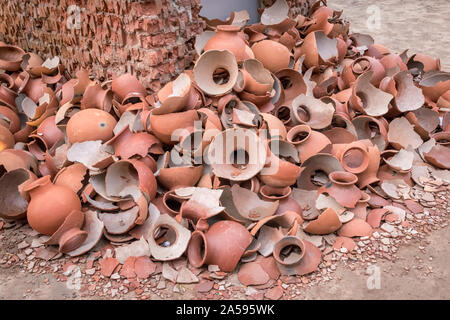 Picture of pile of broken Clay Pottery or Earthenware or traditional Jar on abandoned hut Stock Photo