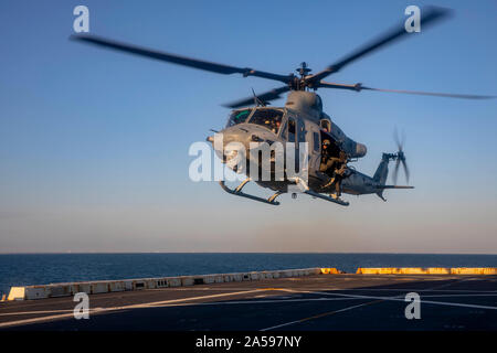 191012-N-GR168-1218 ATLANTIC OCEAN (Oct. 12, 2019) A UH-1Y Huey helicopter, assigned to the Blue Knights of Marine Medium Tiltrotor Squadron (VMM) 365 (Reinforced), prepares to land on the flight deck of the San Antonio-class amphibious transport dock ship USS New York (LPD 21), Oct. 12, 2019. New York is conducting a composite training unit exercise (COMPTUEX) as part of the Bataan Amphibious Ready Group and 26th Marine Expeditionary Unit. (U.S. Navy photo by Mass Communication Specialist 2nd Class Lyle Wilkie/Released) Stock Photo