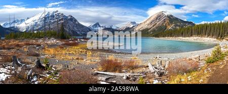 Vibrant Autumn Colors, Distant Snowcapped Mountain Peaks and Wide Panoramic Landscape of upper Kananaskis Lake in Canadian Rockies, Alberta Canada Stock Photo