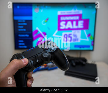 Sony Play Station 4 Pro gaming console on the table with two joysticks and  some games on DVD for PS4 Stock Photo - Alamy