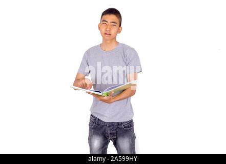 An Asian man holds a book by his arms and look over to the book Stock Photo