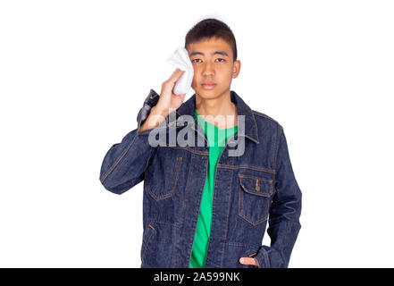 The Young Thai boy in jeans jacket scrub his sweat with white towel Stock Photo