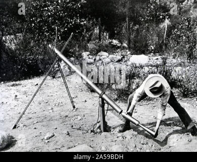 Doctor Goddard, Robert-H Loading a 1918 version of the 'Bazooka' of World War II at MT Wilson OBS., California Stock Photo