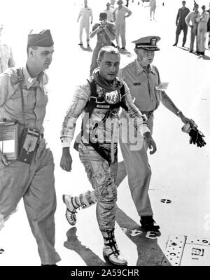 (21 July 1961) --- Astronaut Virgil I. (Gus) Grissom, pilot of the Mercury-Redstone 4 (MR-4) “Liberty Bell 7” spaceflight, arrives aboard the recovery ship, USS Randolph, following his 15-minute, 37-second suborbital space mission. He is flanked by military medical officers. Stock Photo