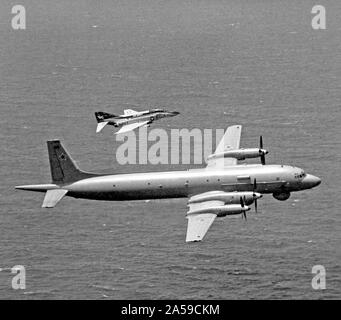 1979 - An air-to-air right side view of an F-4J Phantom II aircraft from Fighter Squadron 161 (VF-161) escorting a Soviet I1-38 May reconnaissance and anti-submarine aircraft.  The Phantom is assigned aboard the aircraft carrier USS MIDWAY (CV-41). Stock Photo