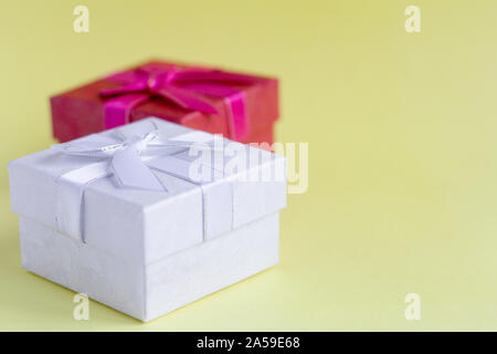 white and red gift boxes on yellow background Stock Photo