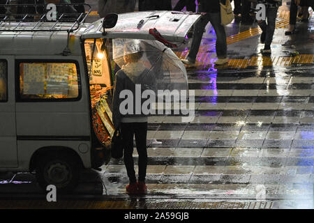 Tokyo, Japan. 18th Oct, 2019. People walk in the streets of the Kabuki-Cho district in Tokyo Japan during a rainy day. Japan is the host country for the 2019 Rugby World Cup and faces a rainy season for the beginning of the quarter finals in which England plays against Australia and New Zealand against Ireland. Photo taken on October 19, 2019. Photo by: Ramiro Agustin Vargas Tabares Credit: Ramiro Agustin Vargas Tabares/ZUMA Wire/Alamy Live News Stock Photo