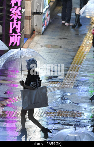 Tokyo, Japan. 18th Oct, 2019. People walk in the streets of the Kabuki-Cho district in Tokyo Japan during a rainy day. Japan is the host country for the 2019 Rugby World Cup and faces a rainy season for the beginning of the quarter finals in which England plays against Australia and New Zealand against Ireland. Photo taken on October 19, 2019. Photo by: Ramiro Agustin Vargas Tabares Credit: Ramiro Agustin Vargas Tabares/ZUMA Wire/Alamy Live News Stock Photo