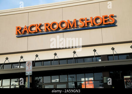 A Logo Sign Outside Of A Rack Room Shoes Retail Store