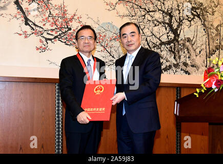 Tokyo, Japan. 18th Oct, 2019. Hideki Minamikawa (L), a famous Japanese ecological and environmental protection expert who has made contributions to the cooperation in ecological and environmental protection between China and Japan, receives the Chinese Government Friendship Award from Chinese Ambassador to Japan Kong Xuanyou in Tokyo, Japan, Oct. 18, 2019. The Chinese Embassy in Japan held a celebration on Friday to congratulate Japanese experts on receiving the Chinese Government Friendship Award. Credit: Hua Yi/Xinhua/Alamy Live News Stock Photo