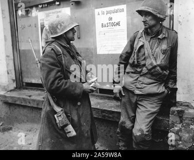 Original caption: Bastogne, Belgium-Weary infantrymen of the 110th Regt., 28th Div., US 1st Army following the German breakthrough in that area. The enemy overran their battalion. (L-R) Pvt. Adam H. Davis and T/S Milford A. Sillars. Dec. 19, 1944 Stock Photo