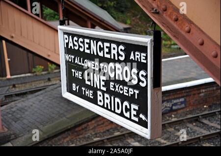 A vintage Passengers not allowed to cross the line sign at Bewdley Station, Severn Valley Railway. Stock Photo