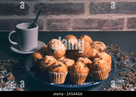 cup of milk next to some tasty muffins on a plate. food concept Stock Photo