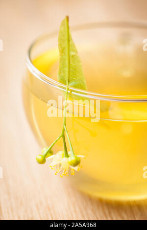 detail of lime blossom tea on wooden table Stock Photo