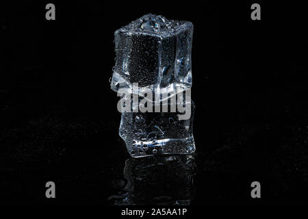 ice cubes on black isolated glass background Stock Photo